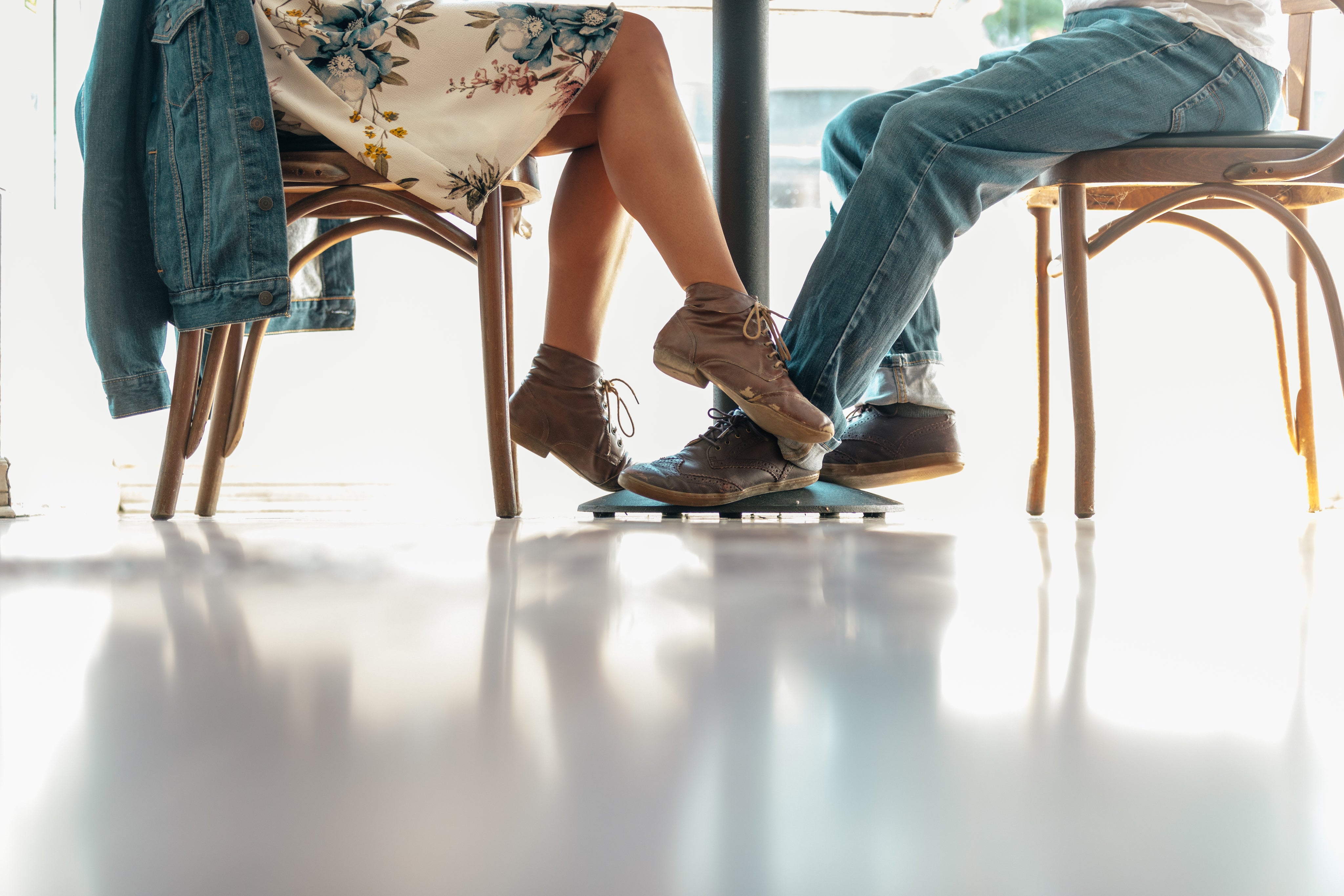 a-woman-plays-footsie-with-a-man-in-a-cafe.jpg