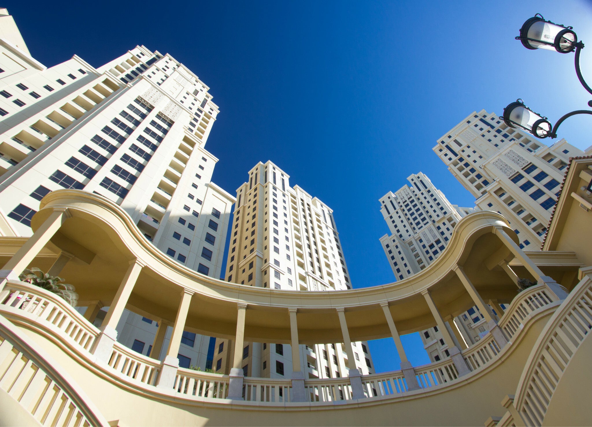 looking-up-toward-tall-buildings-under-blue-sky.jpg